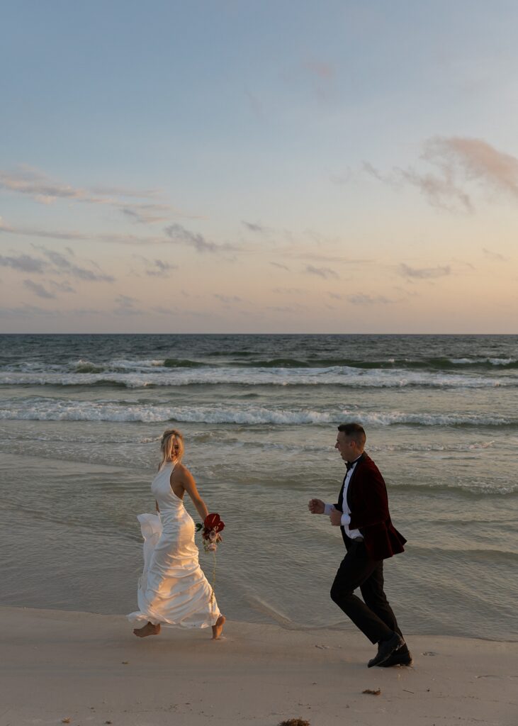 Bride and Groom running on the beach